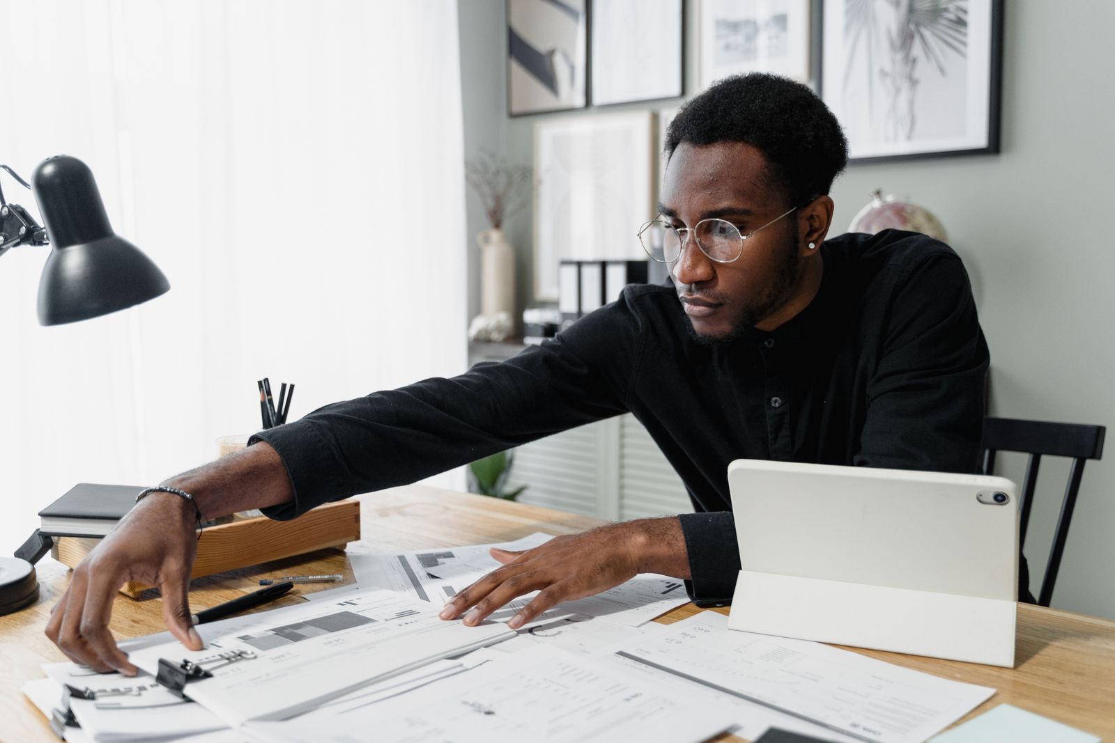 A professional working through financial documents at a bright desk